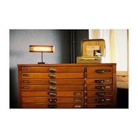 a wooden desk with drawers and a lamp